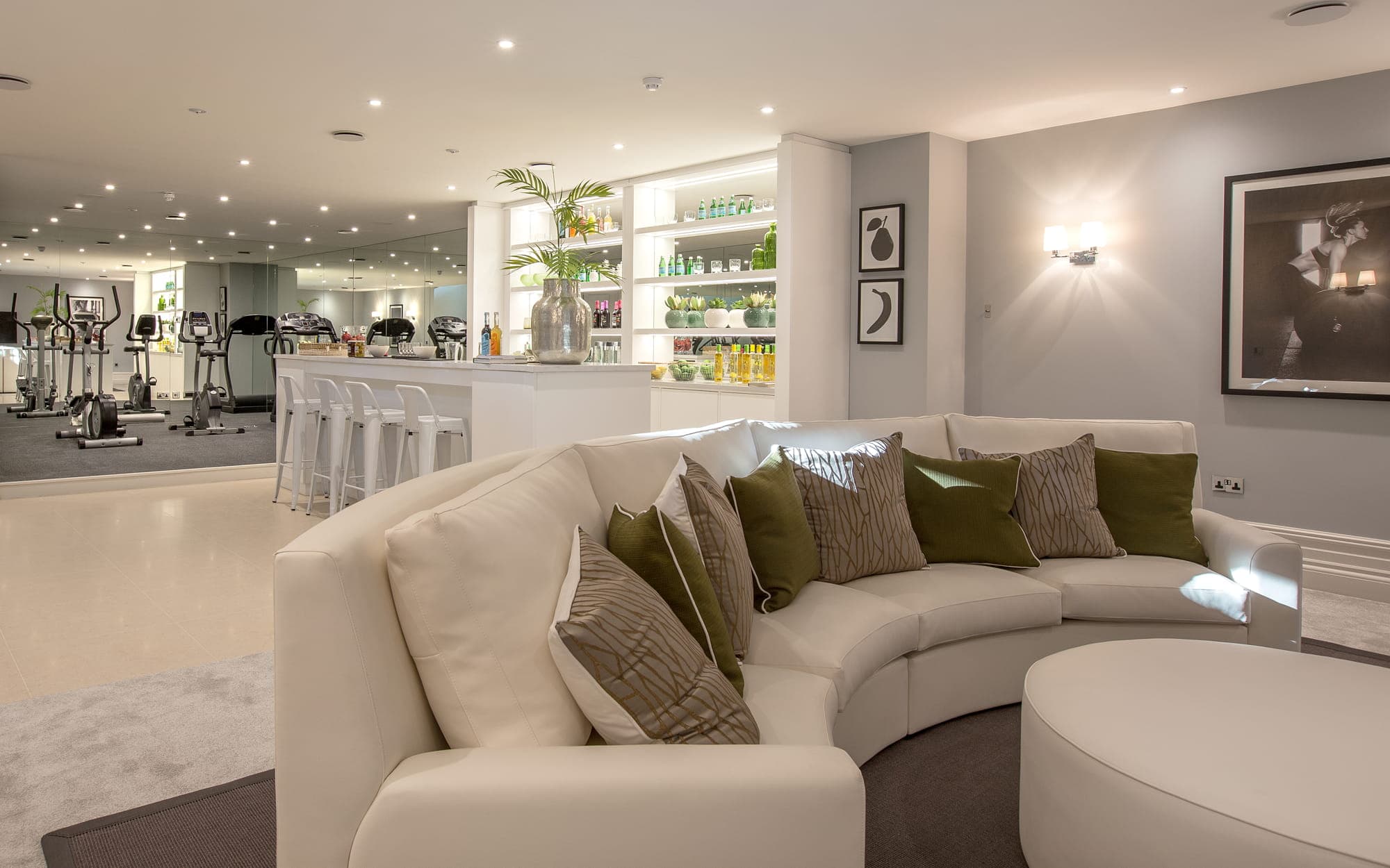 A home bar, fitness, and lounge area created by Aspire Luxury Property Developers at King's View.