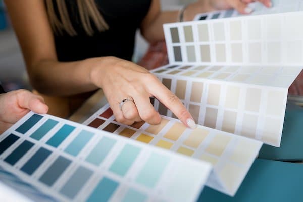 A property owner points to their chosen shade on a colour chart
