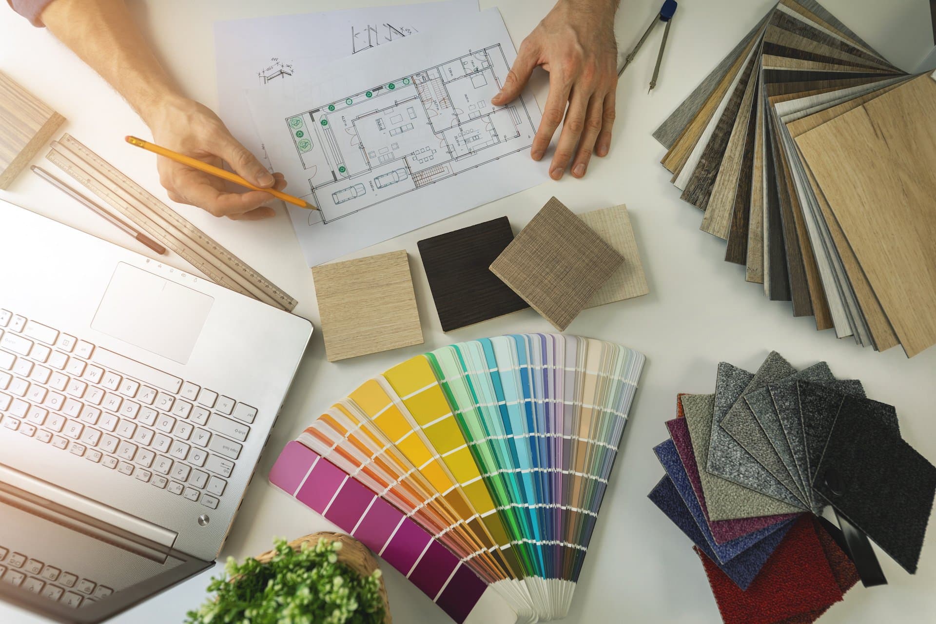 An interior designer uses colour charts and fabric samples to design a room