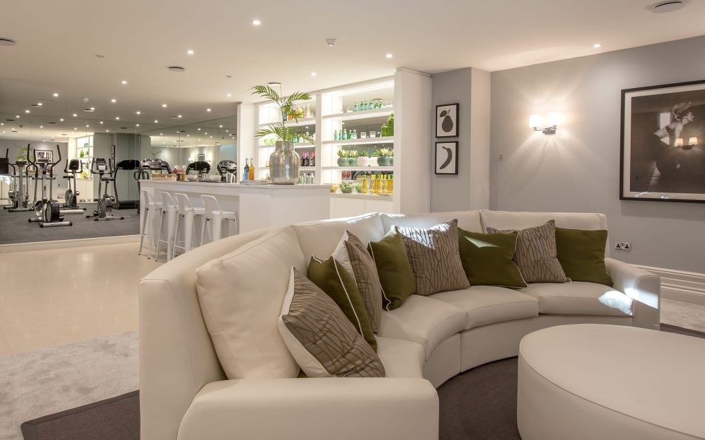 A home bar, fitness, and lounge area created by Aspire Luxury Property Developers at King's View.